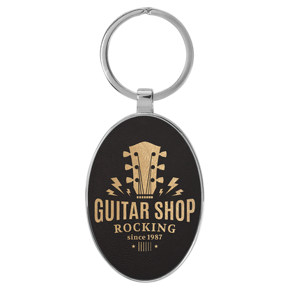3" x 1.75" Black/Gold Metal Oval Leatherette Keychain – item GFT2152