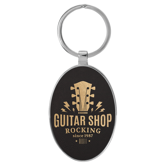 3" x 1.75" Black/Gold Metal Oval Leatherette Keychain – item GFT2152