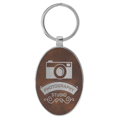 3" x 1.75" Rustic/Silver Metal Oval Leatherette Keychain – item GFT2157