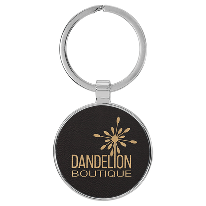 1.5" Black/Gold Metal Round Leatherette Keychain – item GFT2192